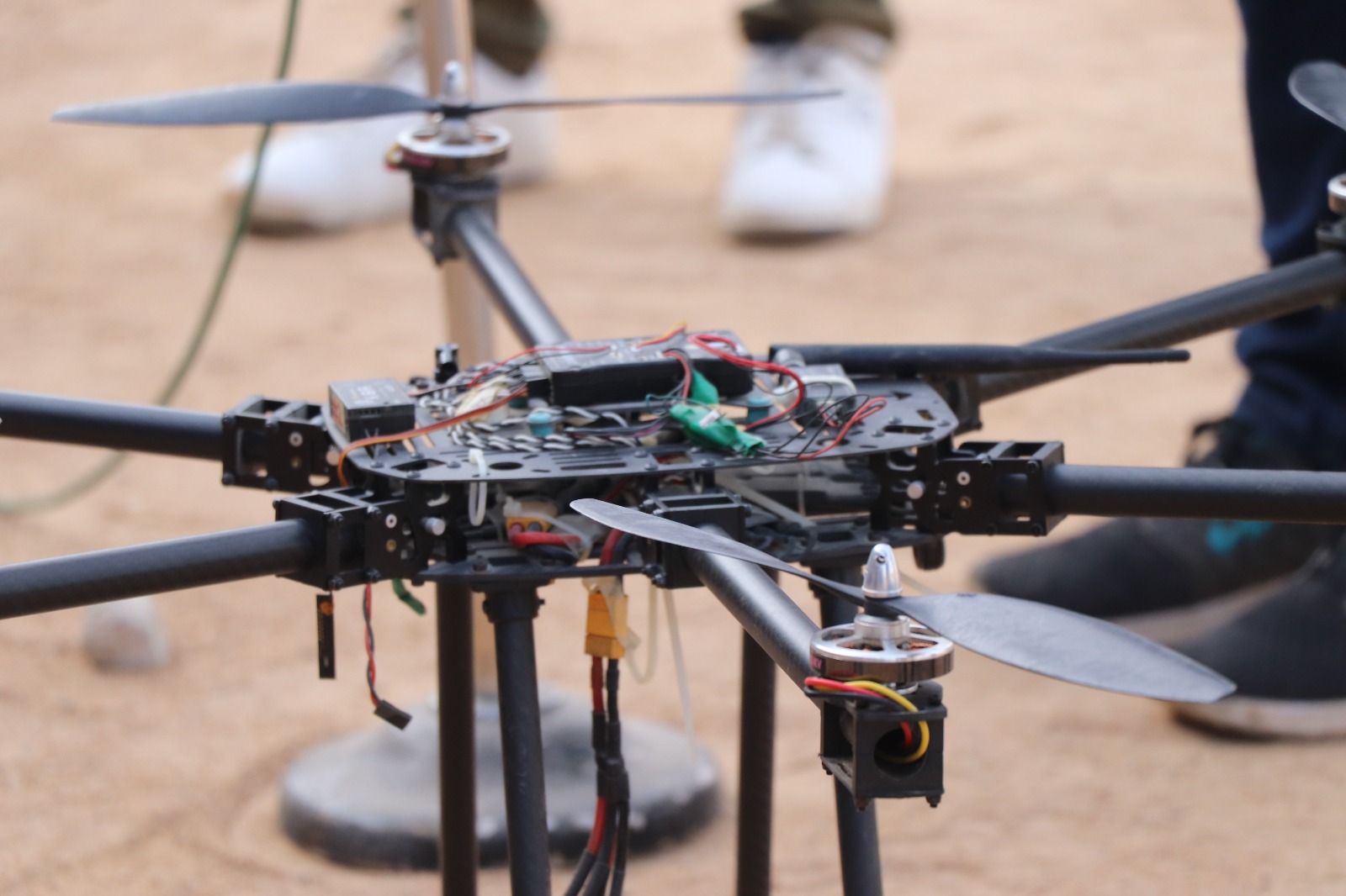 Drone flying in clear blue sky with rocket launch